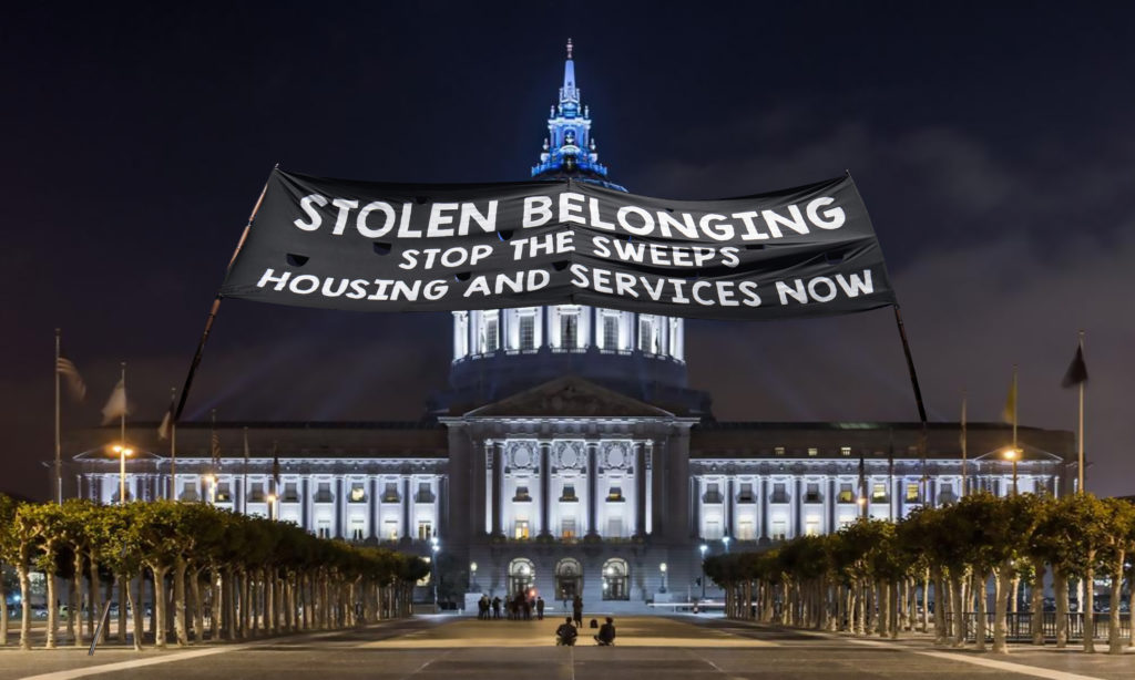 San Francisco City Hall appears draped in a banner that reads "STOLEN BELONGING. Stop the Sweeps. Housing and Services Now."