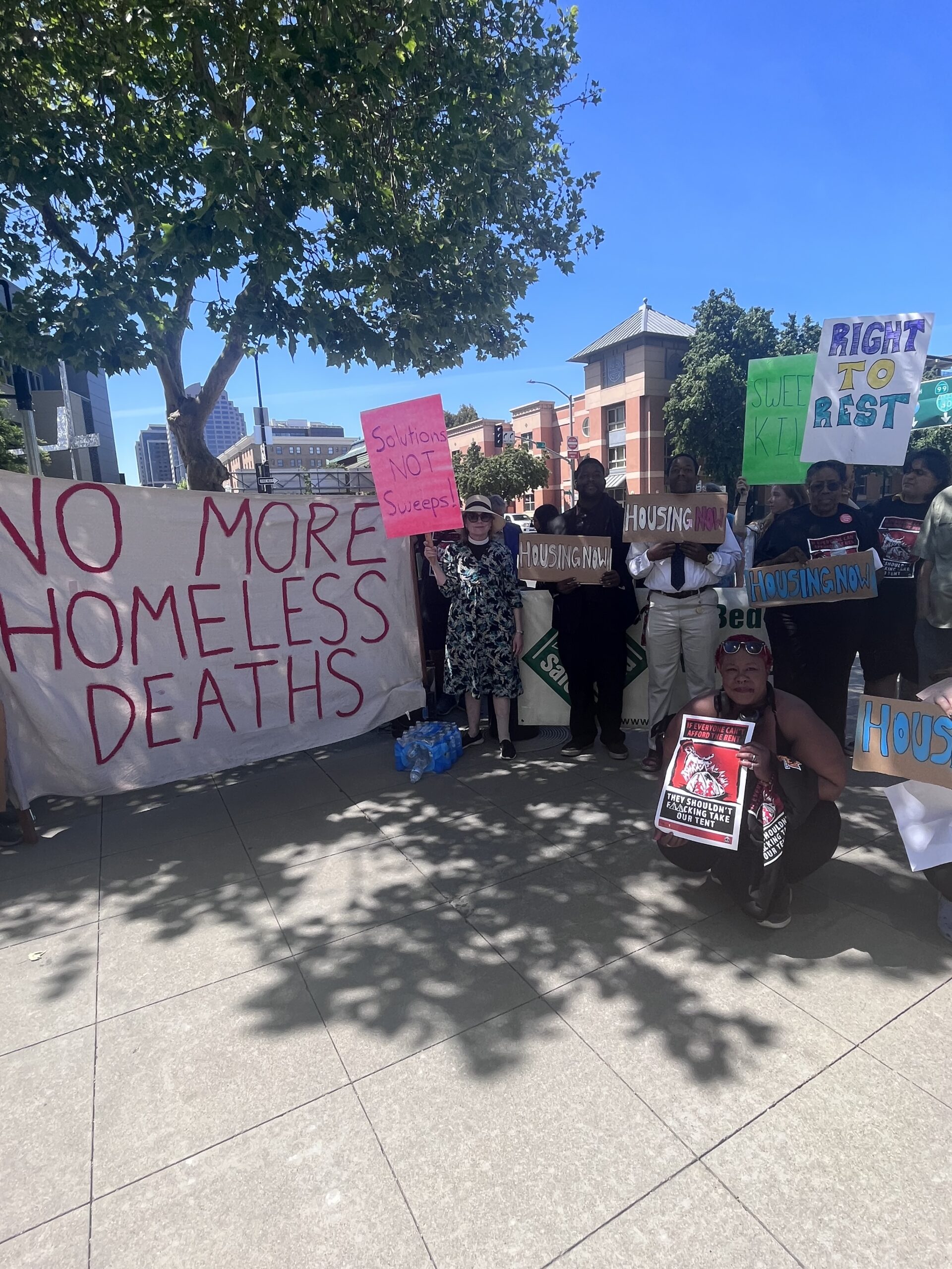Demonstration in Sacramento on April 22, 2024. Large sign reads "No more homeless deaths."